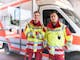 Two paramedics standing in front of ambulance ©  Telekom Deutschland GmbH
