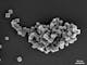 Magnetic, iron manganese nanoparticles where one cuboid particle has an edge length of approximately 25 nm, imaged at low acceleration voltage, ZEISS GeminiSEM 560, Inlens SE image, 1 kV, scale bar 60 nm.