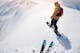 freeriders on steep slope ready to drop in fresh powder snow